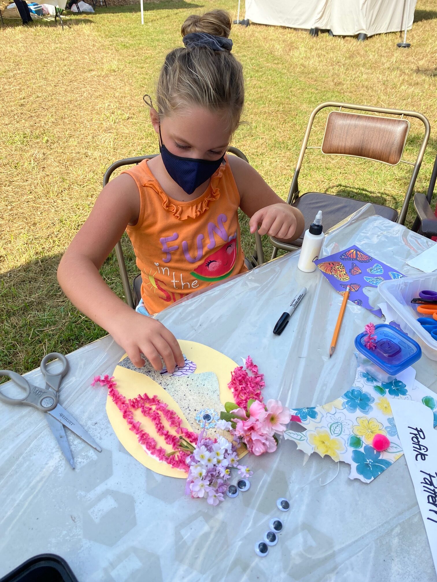 Participant Making Picasso Mask - CAG-CCM Art Booth - Fall, 2021